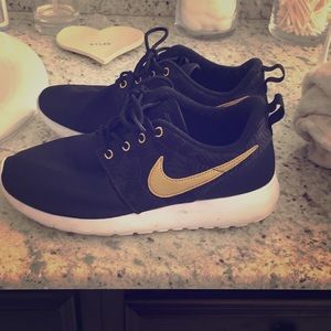 Gold and black Nike running shoes